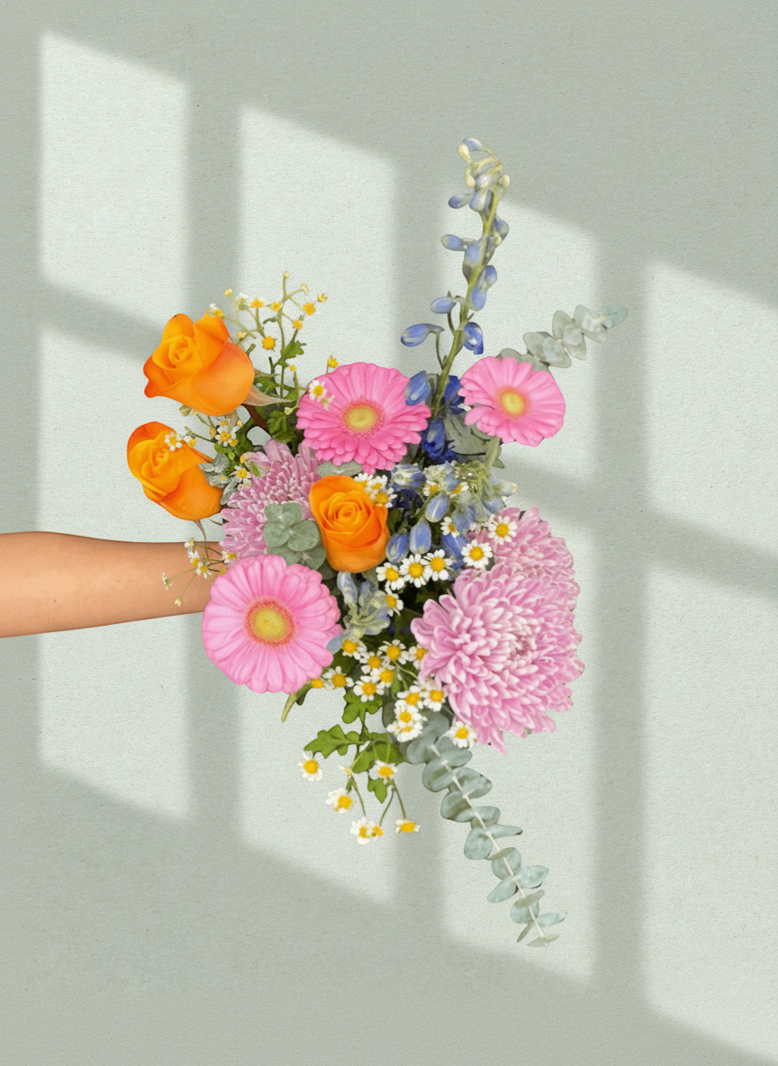 Lakewood Florist hand-tied bouquet with orange roses, pink gerberas, chrysanthemums, blue delphiniums, and eucalyptus.