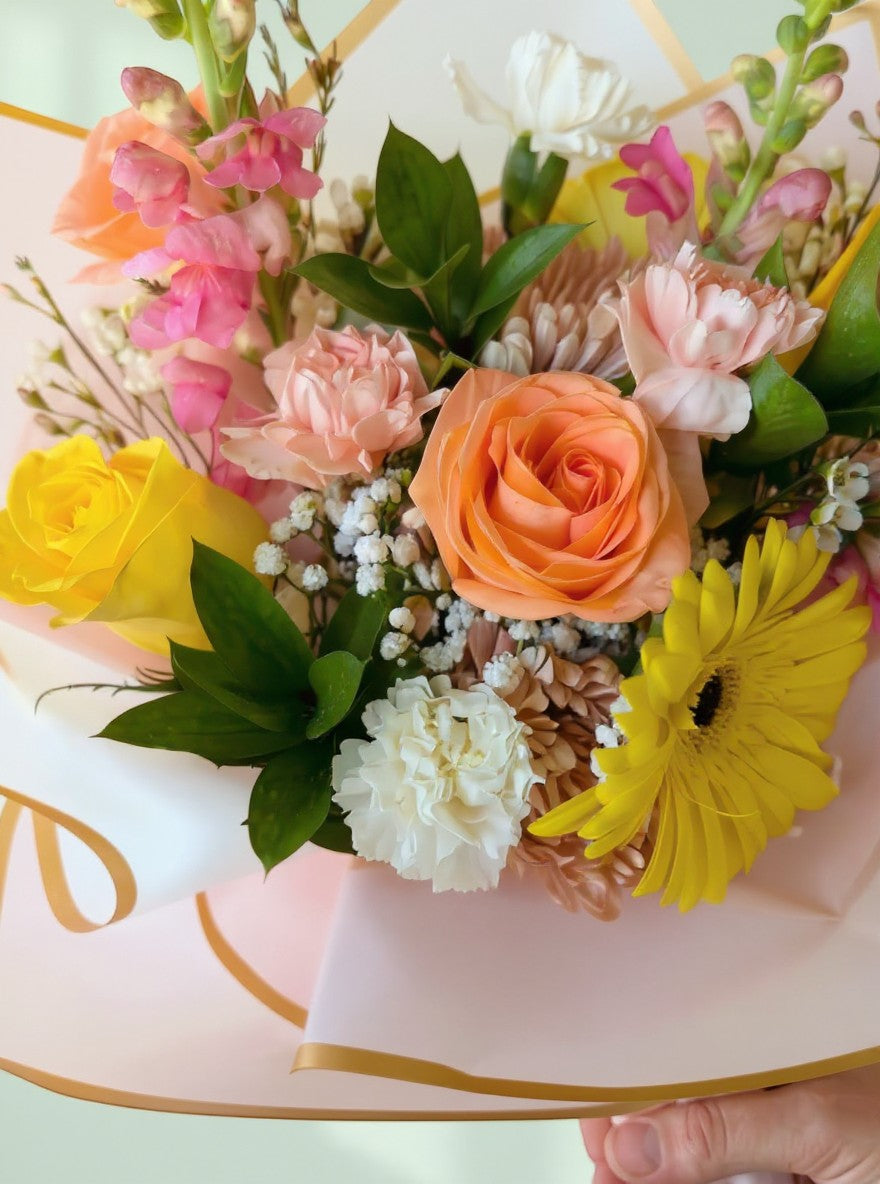 Lakewood Florist Peach and Cream Sunset bouquet with roses, snapdragons, carnations, and gerbera daisies.