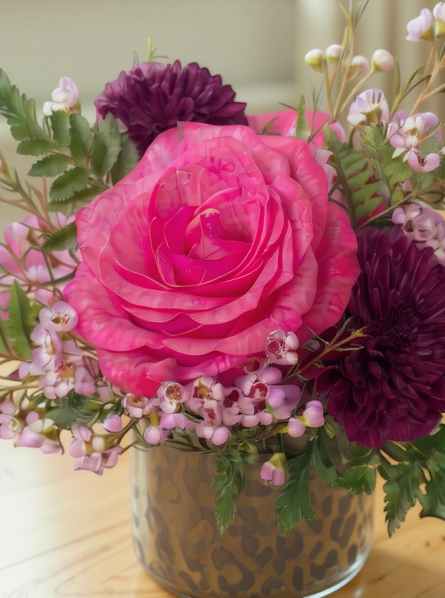 Lakewood Florist arrangement of pink roses and purple dahlias in a cheetah print vase. A bold statement.
