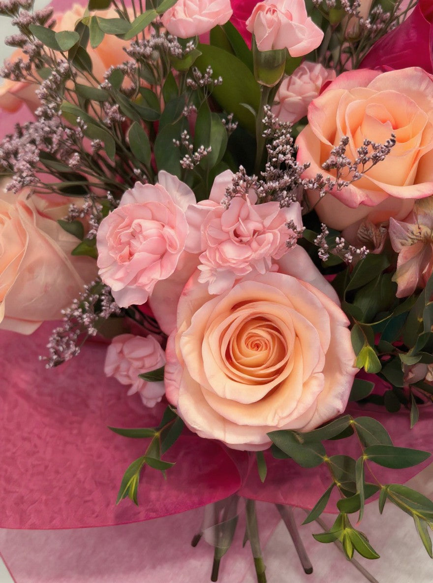 Lakewood Florist Pretty in Pink Bouquet: A vibrant arrangement of pink roses, carnations, and assorted greenery in various shades of pink and peach.