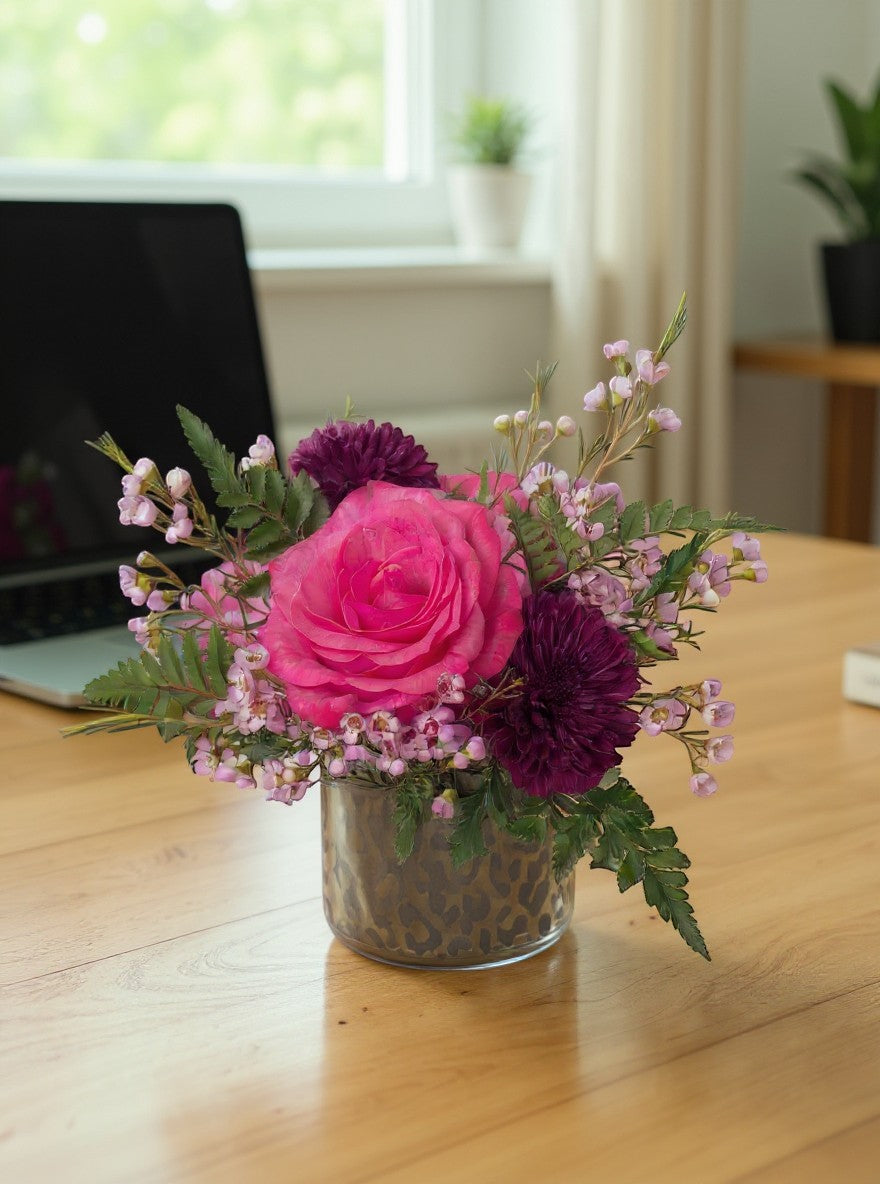 Lakewood Florist She's Bold arrangement: hot pink rose, purple mums, and pink filler flowers in a cheetah print vase.