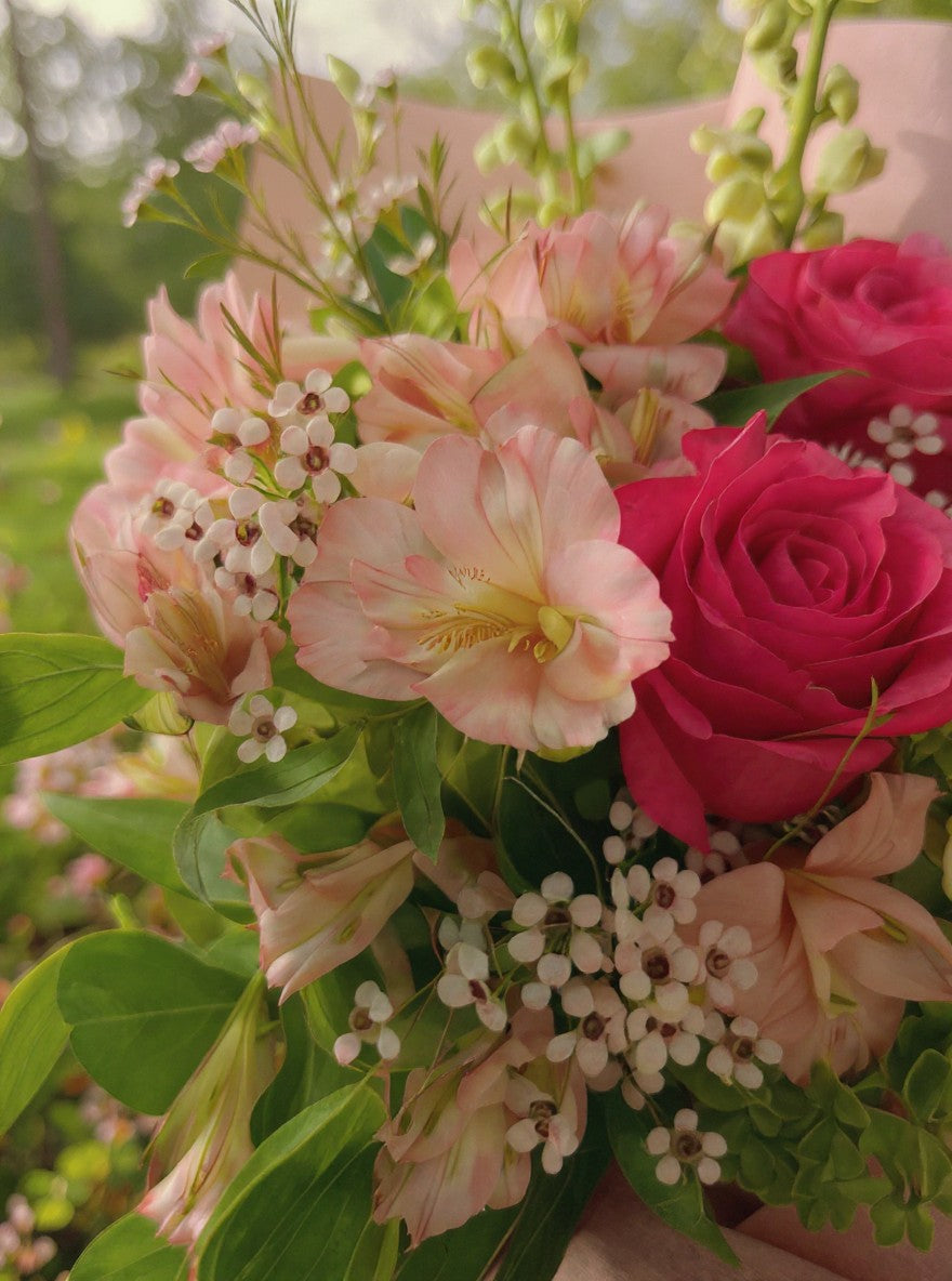 Lakewood Florist Strawberry Matcha Bouquet: Pink roses, alstroemeria, snapdragons, and delicate pink filler flowers in a vibrant arrangement.