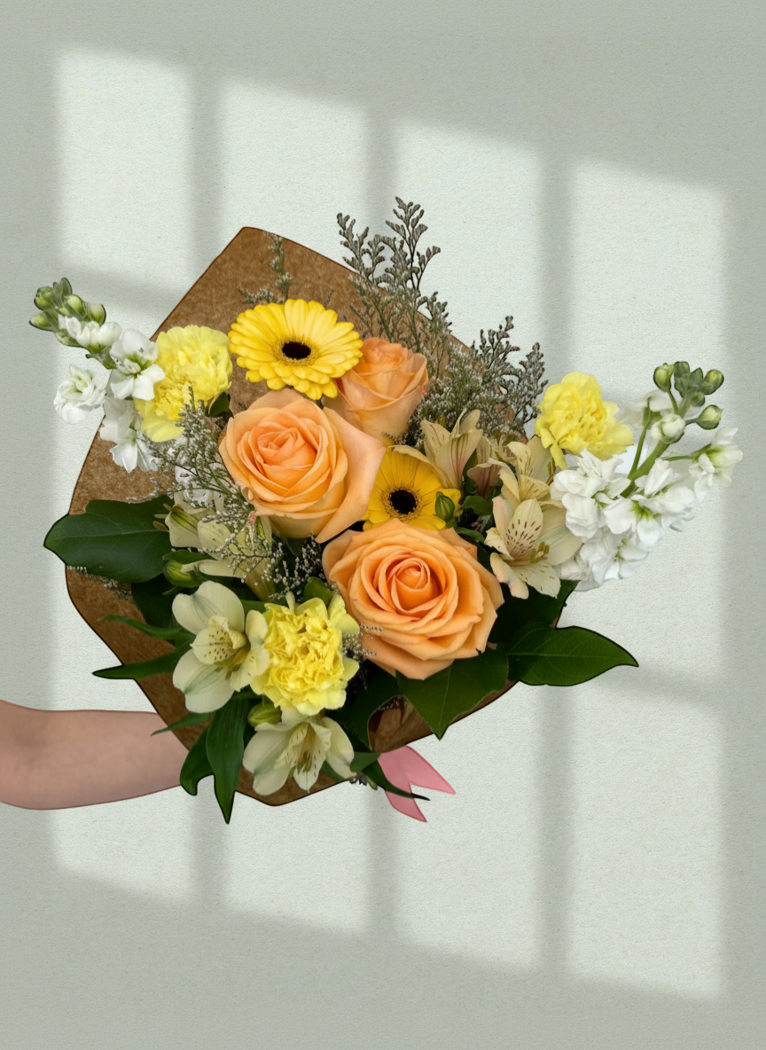 Lakewood Florist Sunny Romance Bouquet: peach roses, yellow gerberas, carnations, alstroemeria, and white stock flowers.