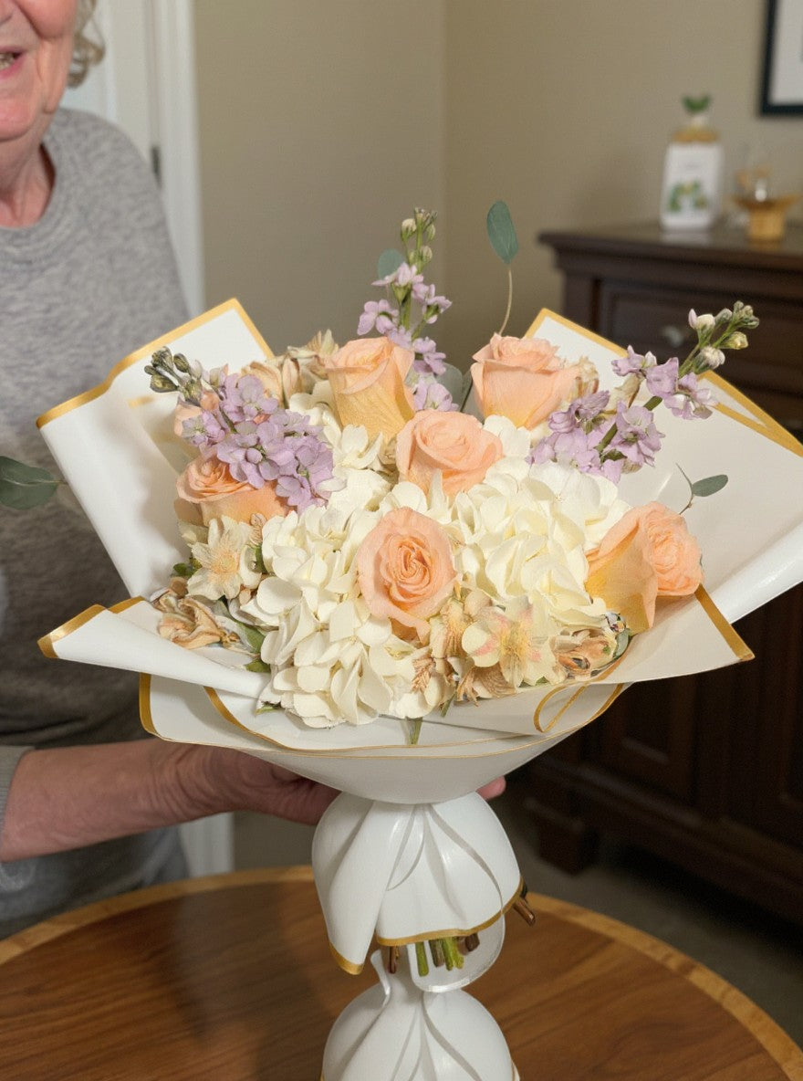 Lakewood Florist Super Blush Bouquet: peach roses, white hydrangea, lavender accents, eucalyptus. Modern floral arrangement.